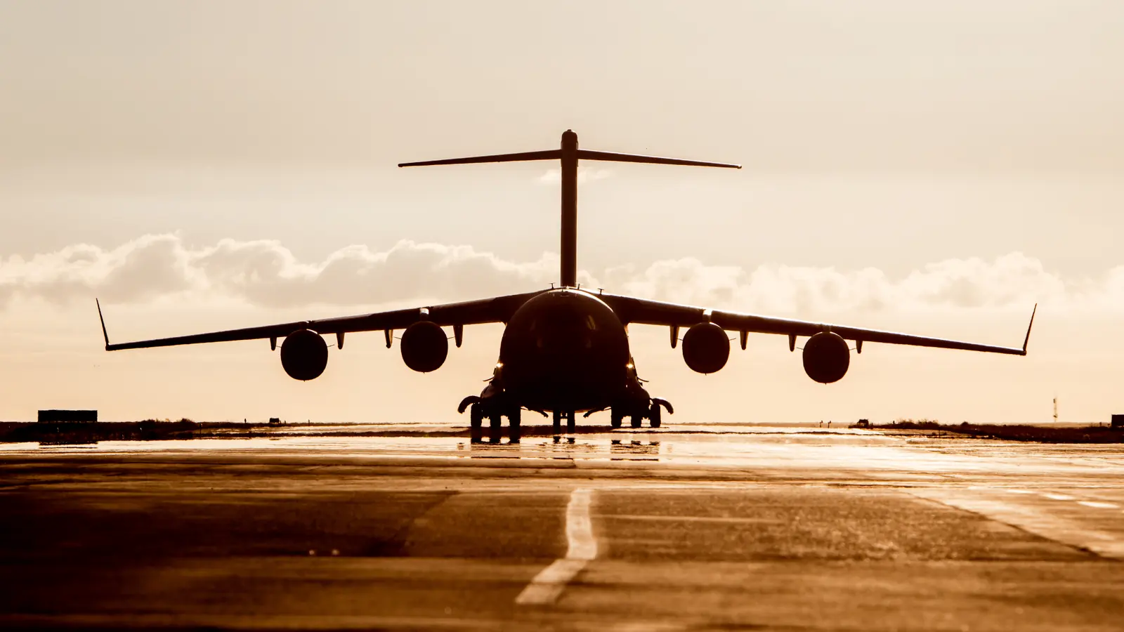 Defence aircraft on runway at sunrise